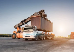 Heavy load being placed on trailer bed by forklift