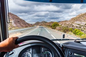 Truck driver looking out at mountains