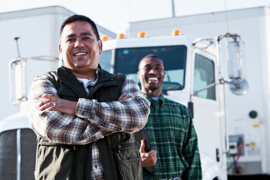 Two individuals in owner-operator trucking roles satisfied with their jobs