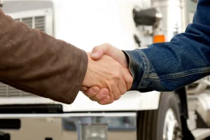 Close-up of a handshake after completing a white glove shipping job