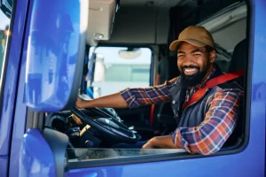 Happy truck driver behind steering wheel